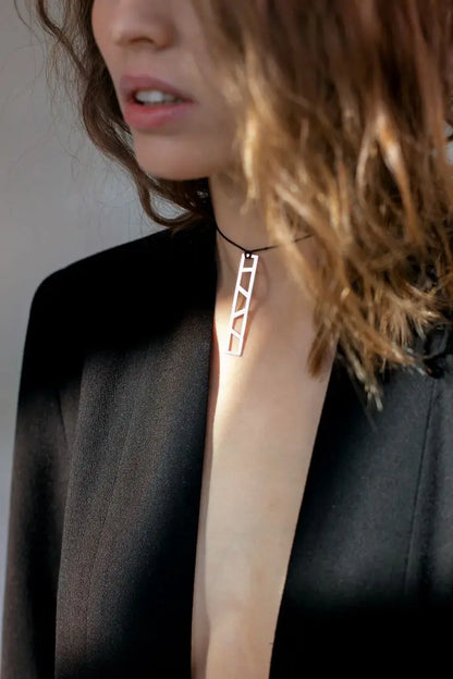Woman wearing minimalistic parametric silver pendant